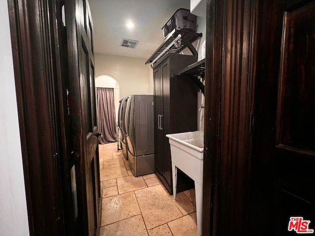 washroom featuring cabinets and washer / dryer