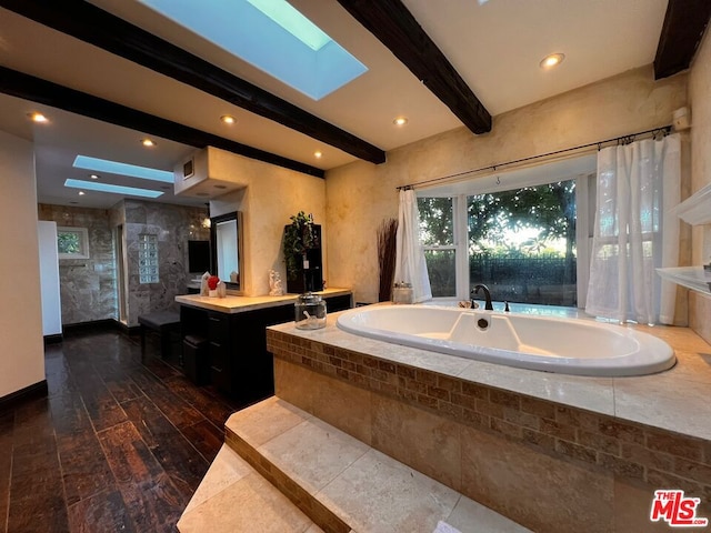 bathroom featuring vanity, a skylight, independent shower and bath, and beam ceiling