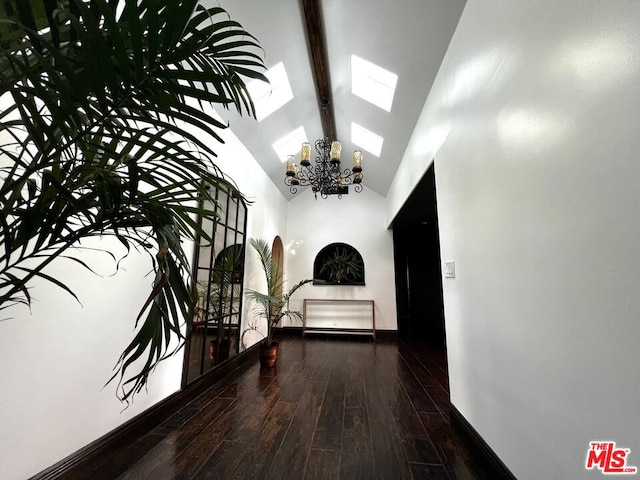 corridor with dark wood-type flooring, an inviting chandelier, high vaulted ceiling, and beamed ceiling