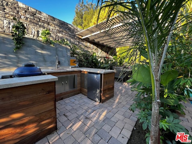 view of patio featuring sink and an outdoor kitchen