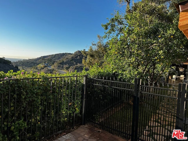 view of gate with a mountain view