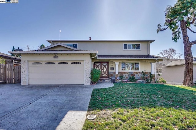 view of front of home featuring a front yard and a garage