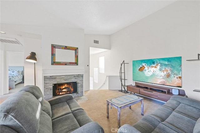 carpeted living room featuring a fireplace and vaulted ceiling