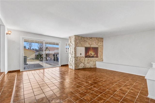 unfurnished living room featuring dark tile patterned floors