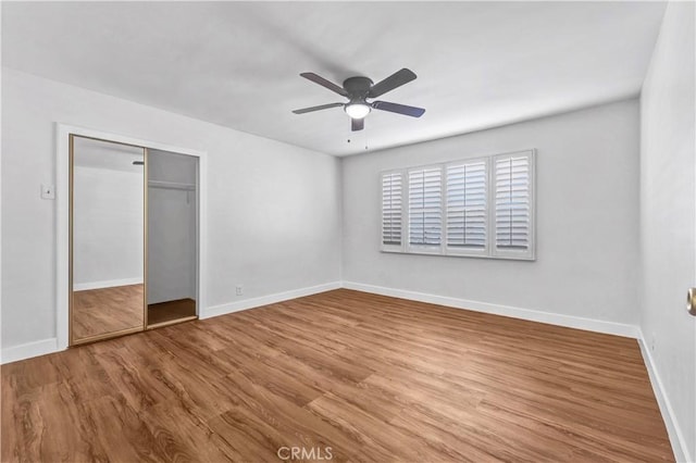 unfurnished bedroom featuring a closet, ceiling fan, and hardwood / wood-style flooring