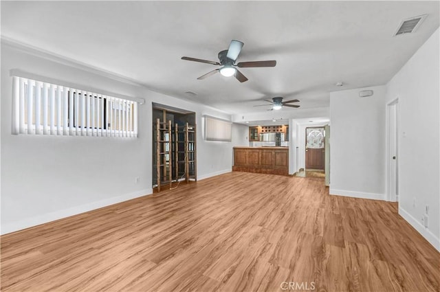 unfurnished living room with ceiling fan and light hardwood / wood-style flooring