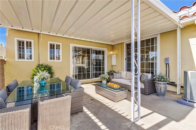 view of patio / terrace with central air condition unit and an outdoor living space