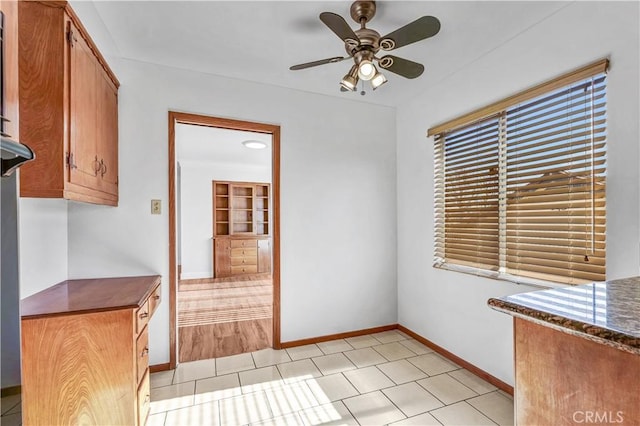 interior space featuring ceiling fan and light tile patterned flooring