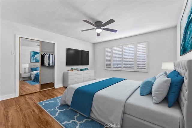 bedroom with a closet, ceiling fan, and hardwood / wood-style flooring