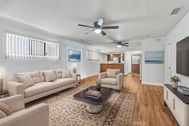 living room featuring ceiling fan and light wood-type flooring