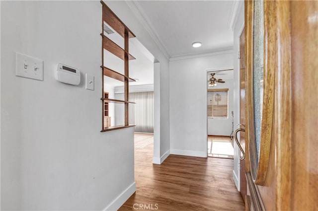 hallway featuring crown molding and hardwood / wood-style flooring