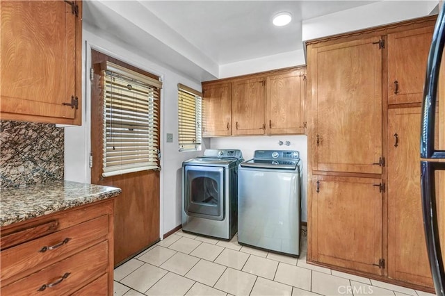 laundry area featuring cabinets and washing machine and clothes dryer