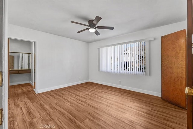 empty room featuring ceiling fan and light hardwood / wood-style flooring