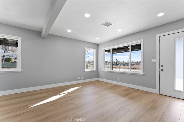 entryway with light hardwood / wood-style flooring and beam ceiling