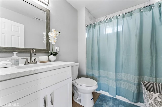 bathroom with toilet and vanity