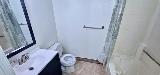 bathroom with toilet, tile patterned flooring, and vanity