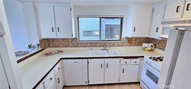 kitchen with white appliances, white cabinetry, and sink