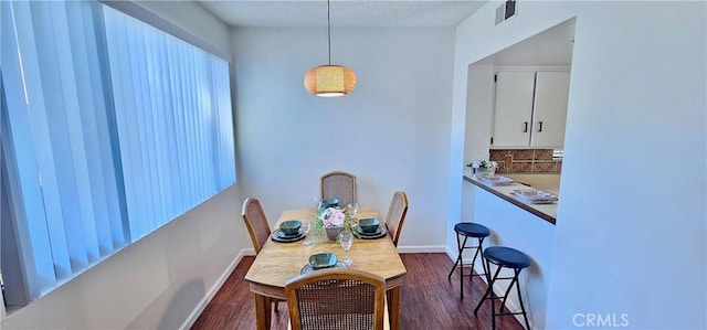 dining room with dark hardwood / wood-style flooring