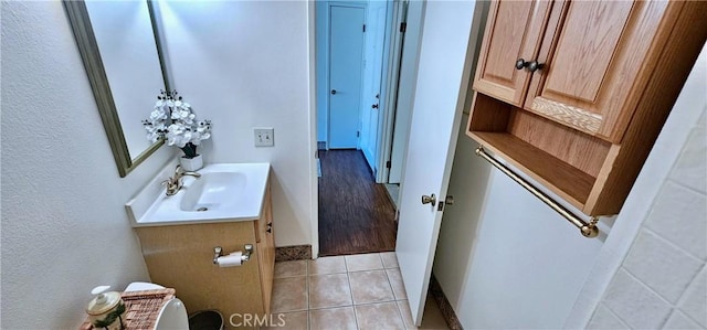 bathroom featuring vanity, tile patterned flooring, and toilet