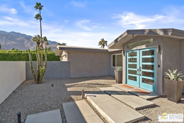 doorway to property featuring a patio, french doors, and a mountain view