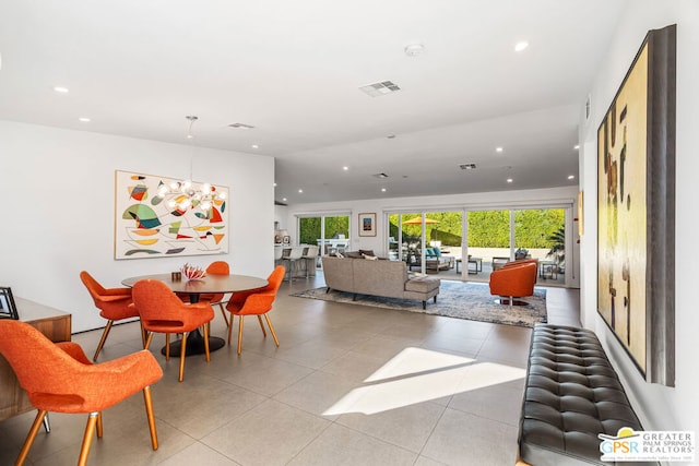 dining area with a notable chandelier and light tile patterned floors