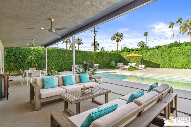 view of patio with an outdoor hangout area, ceiling fan, and a fenced in pool