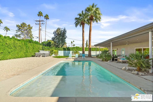 view of swimming pool featuring a patio area and a jacuzzi