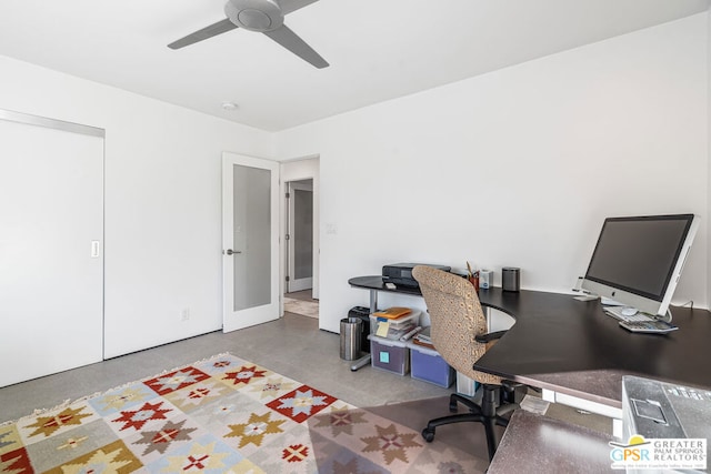 office space with concrete floors and ceiling fan