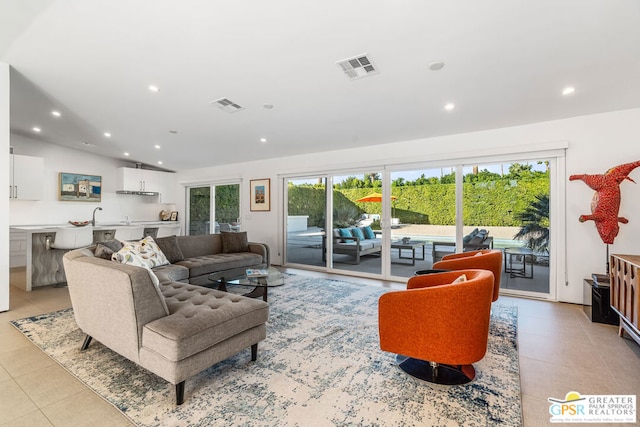 tiled living room featuring lofted ceiling and plenty of natural light