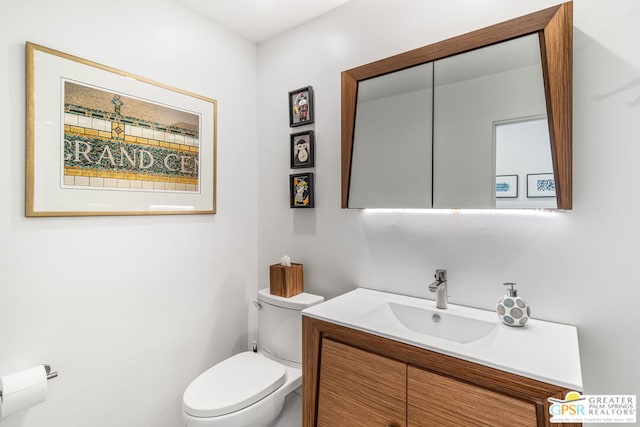 bathroom featuring toilet and vanity