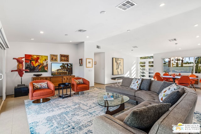 living room featuring lofted ceiling and a notable chandelier