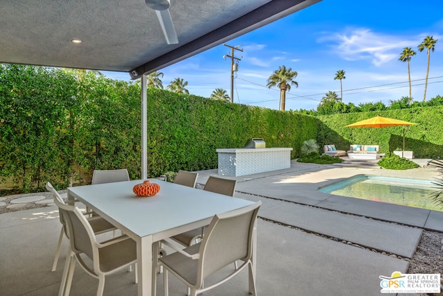 view of patio featuring ceiling fan and a fenced in pool