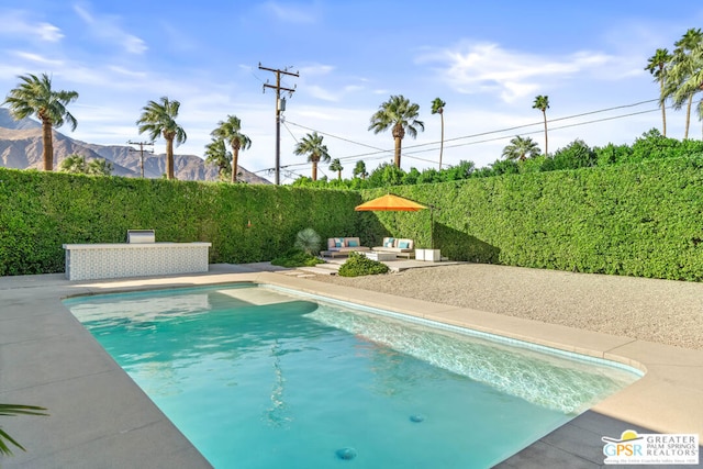 view of pool featuring a patio and a mountain view