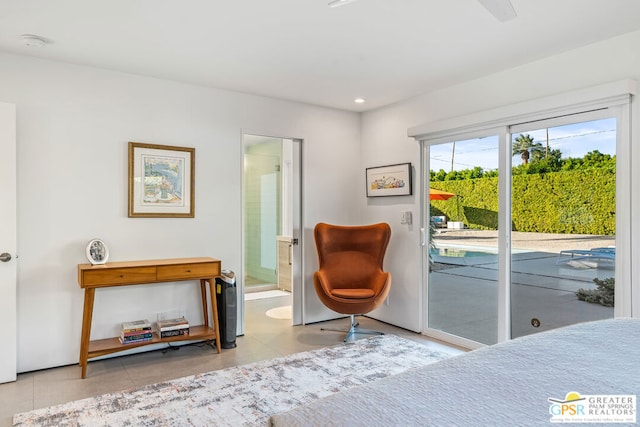 bedroom with access to outside, connected bathroom, and light tile patterned floors