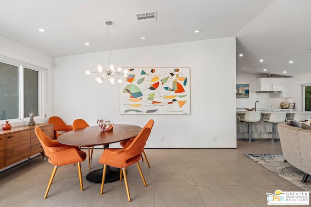 dining space featuring an inviting chandelier and light tile patterned flooring