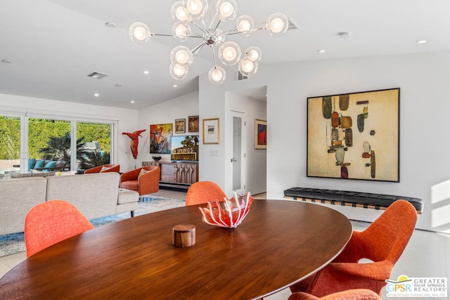 dining room with lofted ceiling and a chandelier