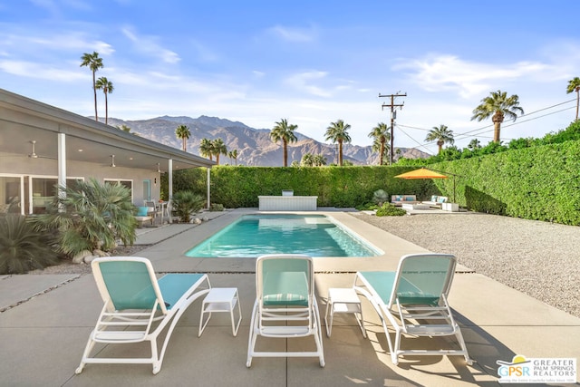 view of pool featuring a patio and a mountain view