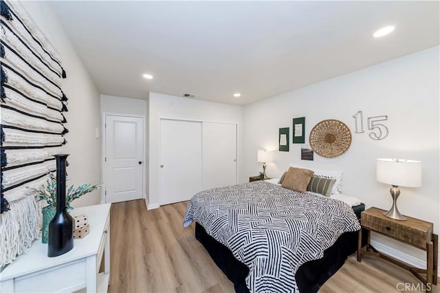 bedroom with a closet and light wood-type flooring