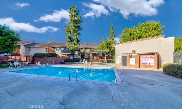 view of swimming pool featuring a pergola and a patio area