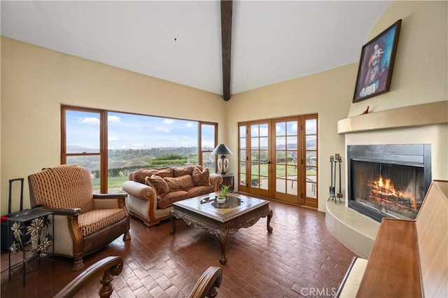 living room with lofted ceiling with beams and french doors