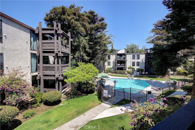 view of pool featuring a lawn