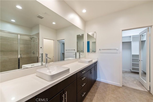 bathroom featuring an enclosed shower, vanity, and tile patterned floors