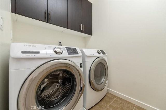 washroom with cabinets, light tile patterned flooring, and separate washer and dryer