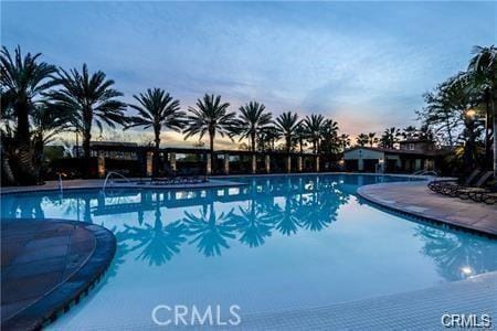 view of pool at dusk