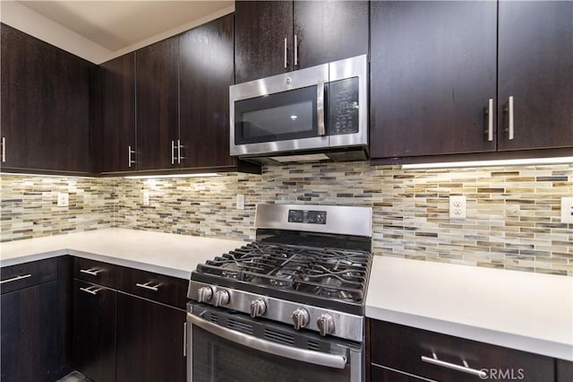 kitchen featuring decorative backsplash, stainless steel appliances, and dark brown cabinetry