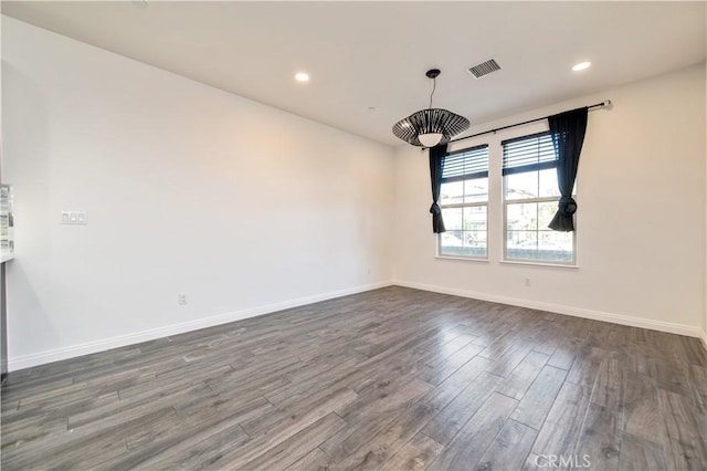 spare room with dark hardwood / wood-style flooring