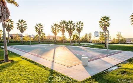 view of sport court with a yard