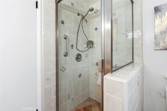 bathroom featuring a shower with shower door