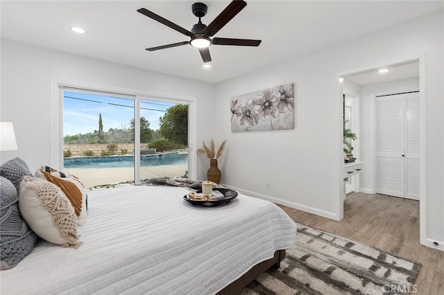 bedroom featuring ceiling fan, hardwood / wood-style flooring, and access to exterior