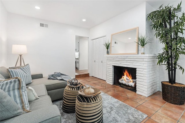 living room featuring a fireplace and light tile patterned floors